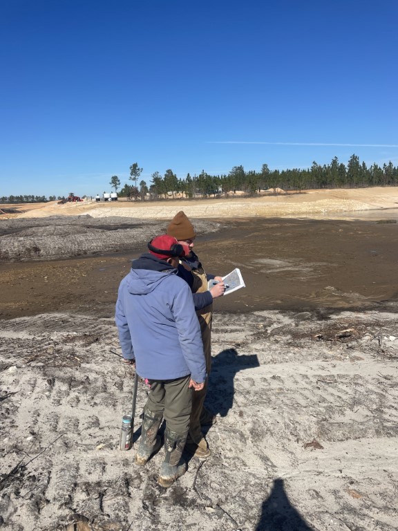 Reviewing plans in lake bed