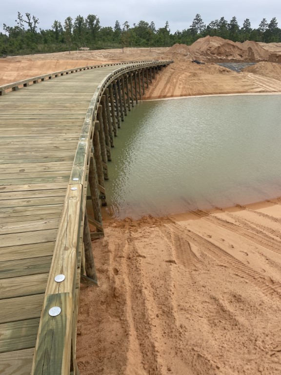 Completed cart path over partially filled lake