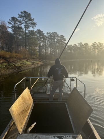 AES worker on an electrofishing boat