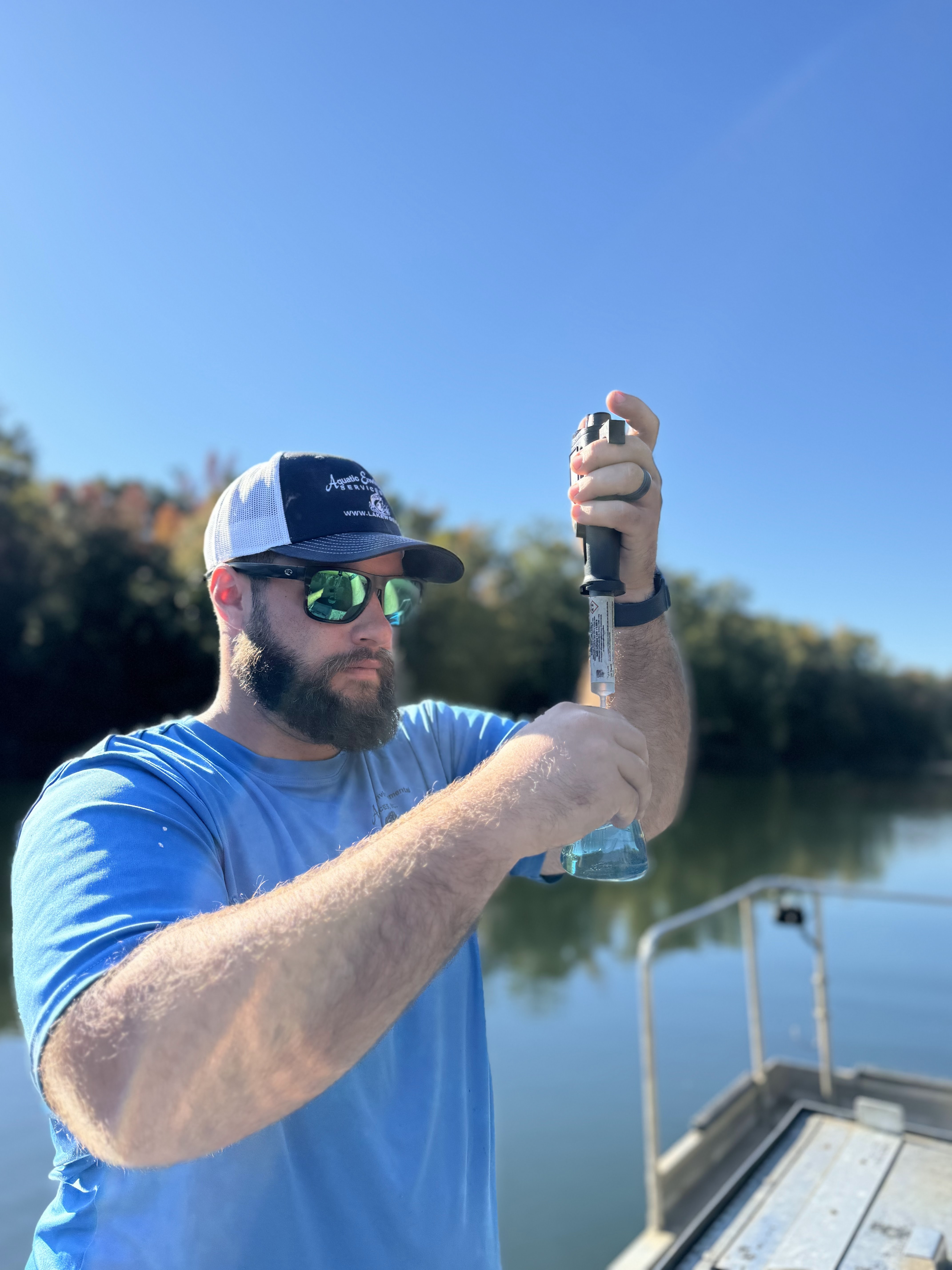 AES worker testing the water quality of a lake